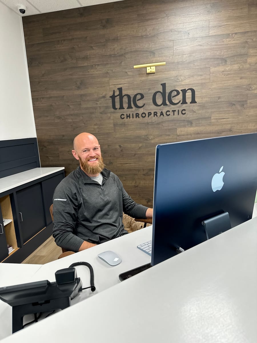 The front desk at The Den Chiropractic, under the clinic's wordmark